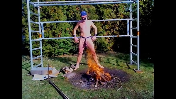 totally naked slave exposed in harness public outdoor body writing campfire BDSM CBT