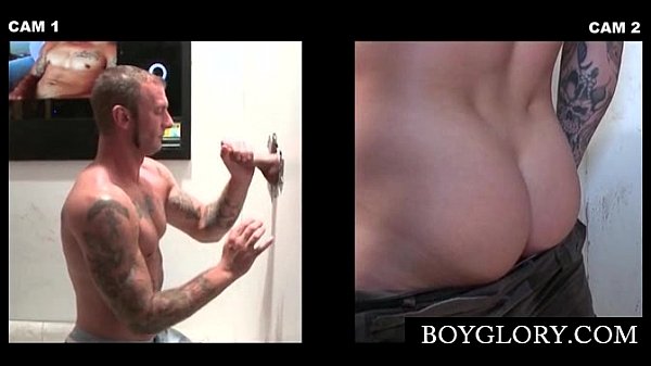 Muscled tattooed gay sucking cock on gloryhole